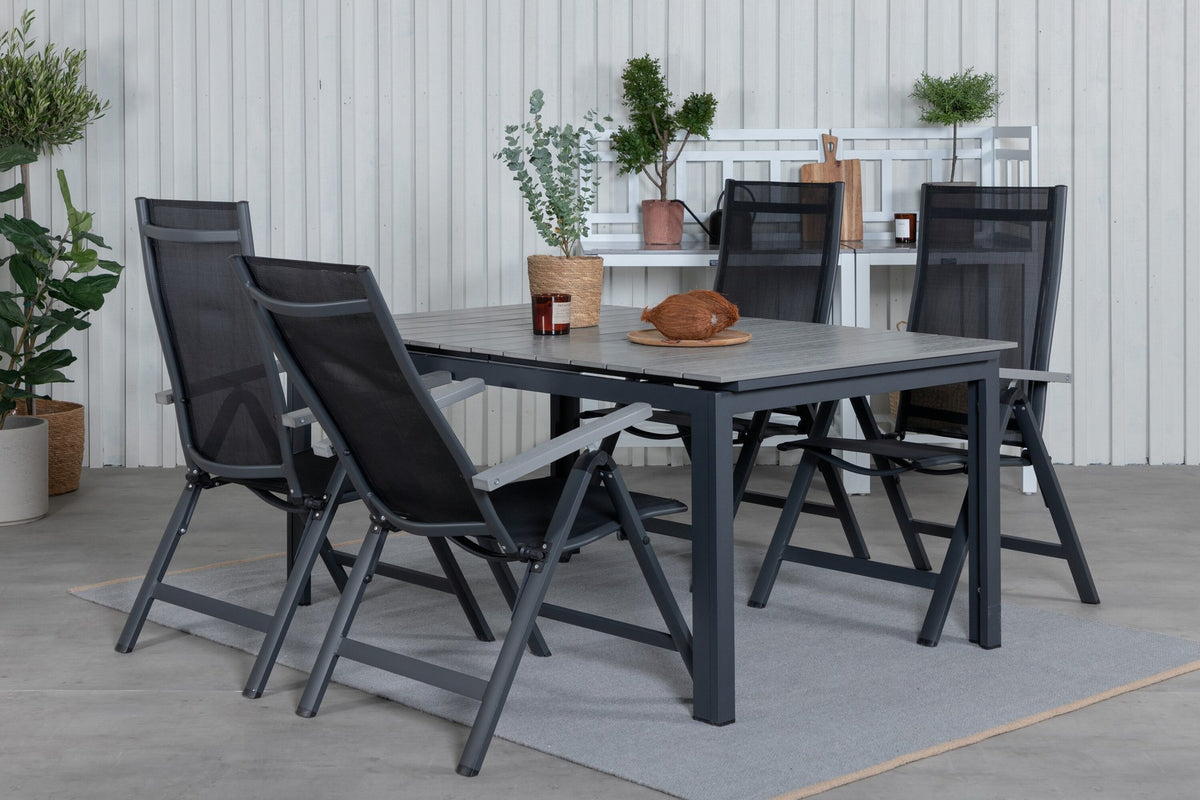 Schwarzer Albany-Stuhl mit grauem Teakholz und Textilene neben ausziehbarem Levels Gartentisch aus Aluminium und Aintwood in Schwarz/Grau