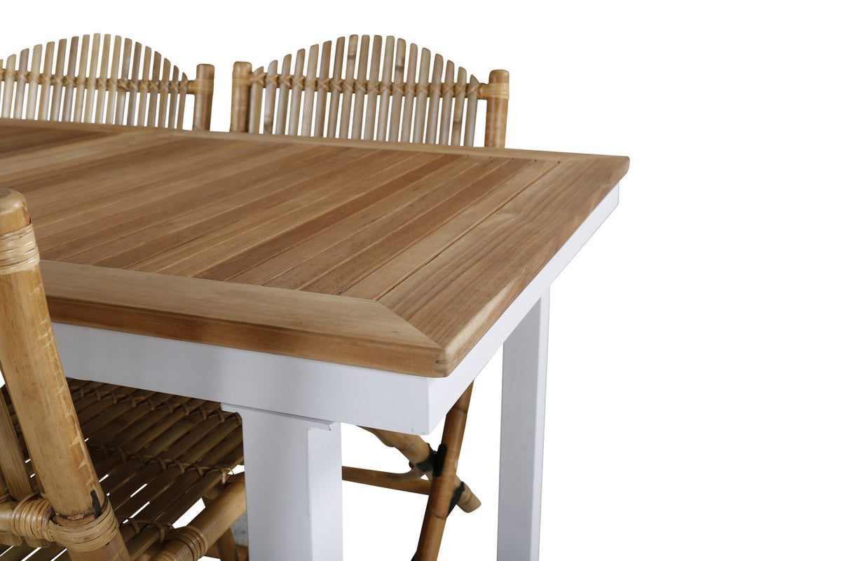 Foto zeigt einen Cafe Stuhl mit Rattan-Beinen und Stoffbezug in Natur sowie einen rechteckigen Teakholz-Esstisch mit weissem Aluminiumgestell.