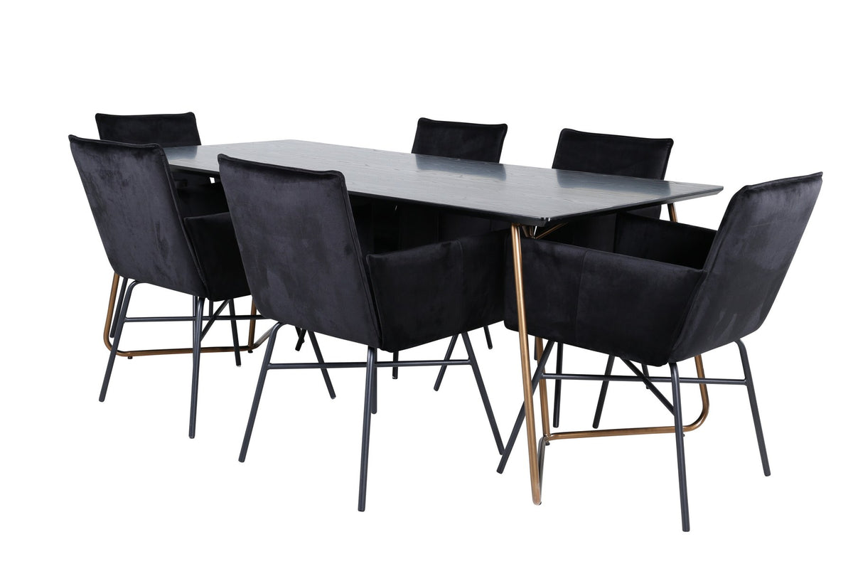 Petra Esszimmerset: Esstisch mit schwarzer MDF-Platte und Furnier in Used-Optik, sechs Stühle mit Samtbezug in Kupfer/Schwarz und Eisenbeinen.