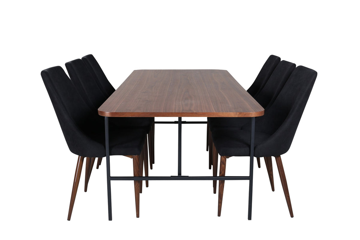 Rechteckiger Esstisch mit MDF-Tischplatte in Nussbaumfurnier und schwarzem Stahlgestell, kombiniert mit zwei schwarzen Polyester-Stühlen.