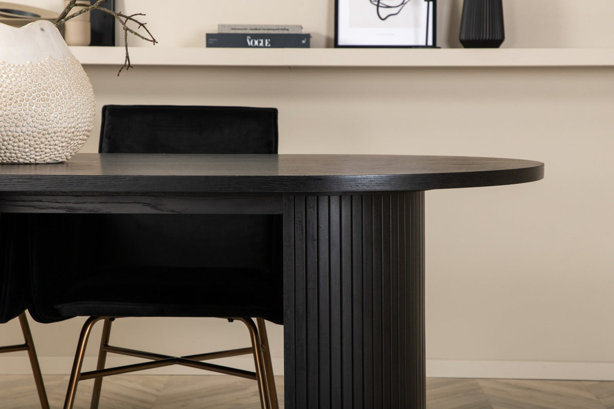 Ovaler Esstisch 200x90 cm aus MDF mit schwarzem Furnier und vier Esszimmerstühle mit kupferfarbenen Beinen und schwarzem Samtbezug.
