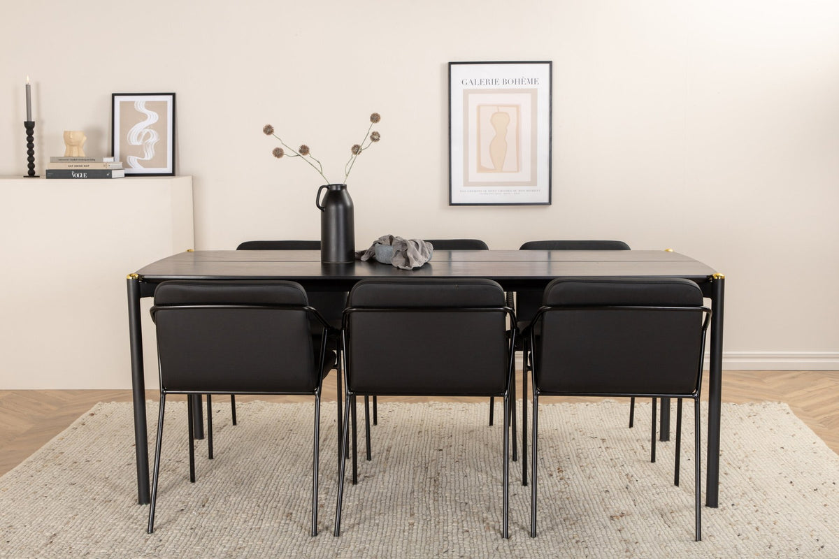 Schwarzer Esstisch aus MDF mit Furnier und Eisenbeinen, kombiniert mit sechs Stühlen aus Kunstleder und schwarzem Metallgestell.
