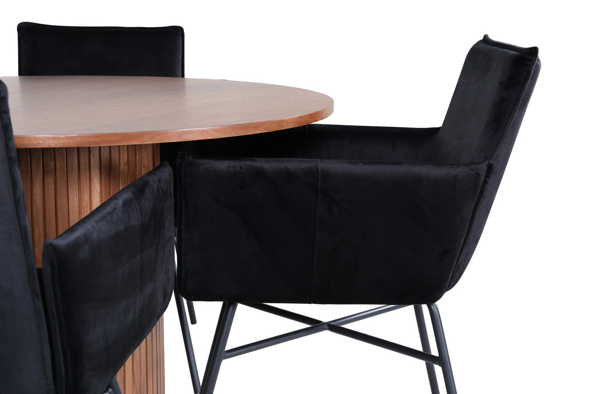 Rundes Esszimmerset mit Nussbaum-Tischplatte Ø110cm aus MDF und vier schwarzen Stühlen mit Samtsitz und Beinen aus Eisen.