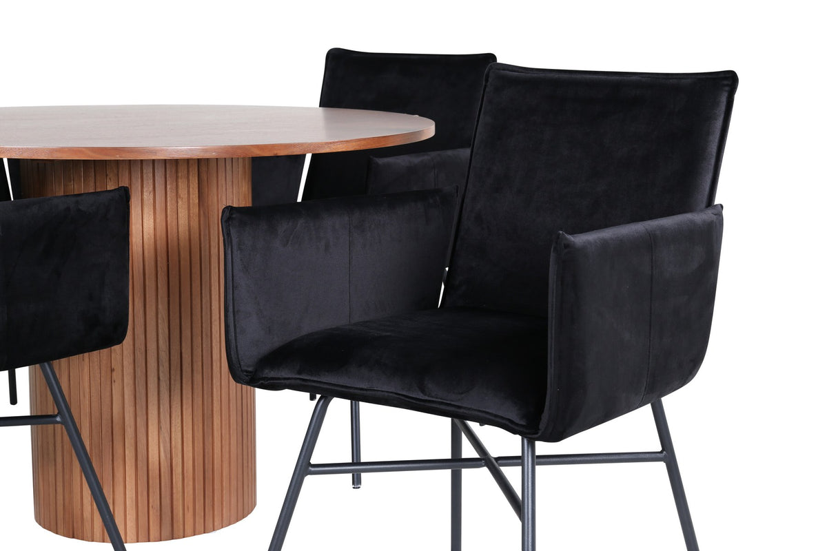 Rundes Esszimmerset mit Nussbaum-Tischplatte Ø110cm aus MDF und vier schwarzen Stühlen mit Samtsitz und Beinen aus Eisen.