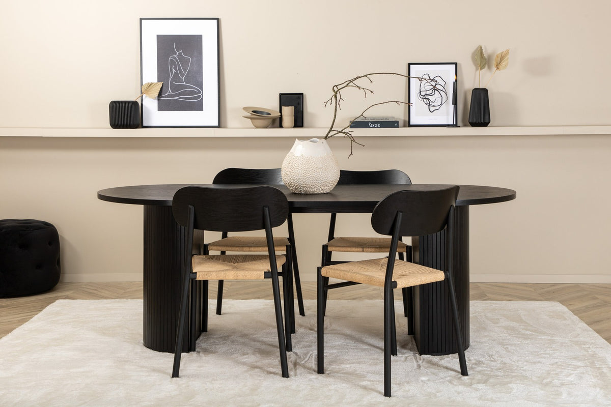 Rundes Esszimmerset Bianca mit Stuhl Polly: Tisch aus MDF und Furnier in Walnuss, vier schwarze Stühle mit Metallbeinen und Seilsitzen.