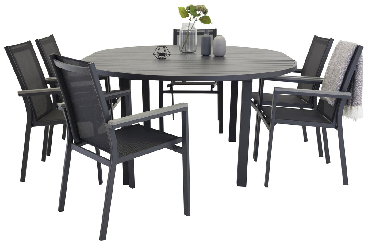 Anthrazitfarbenes Gartentischset aus Aluminium mit ausziehbarem Esstisch, schwarzer Tischplatte und stapelbaren Parma-Stühlen im Freien.