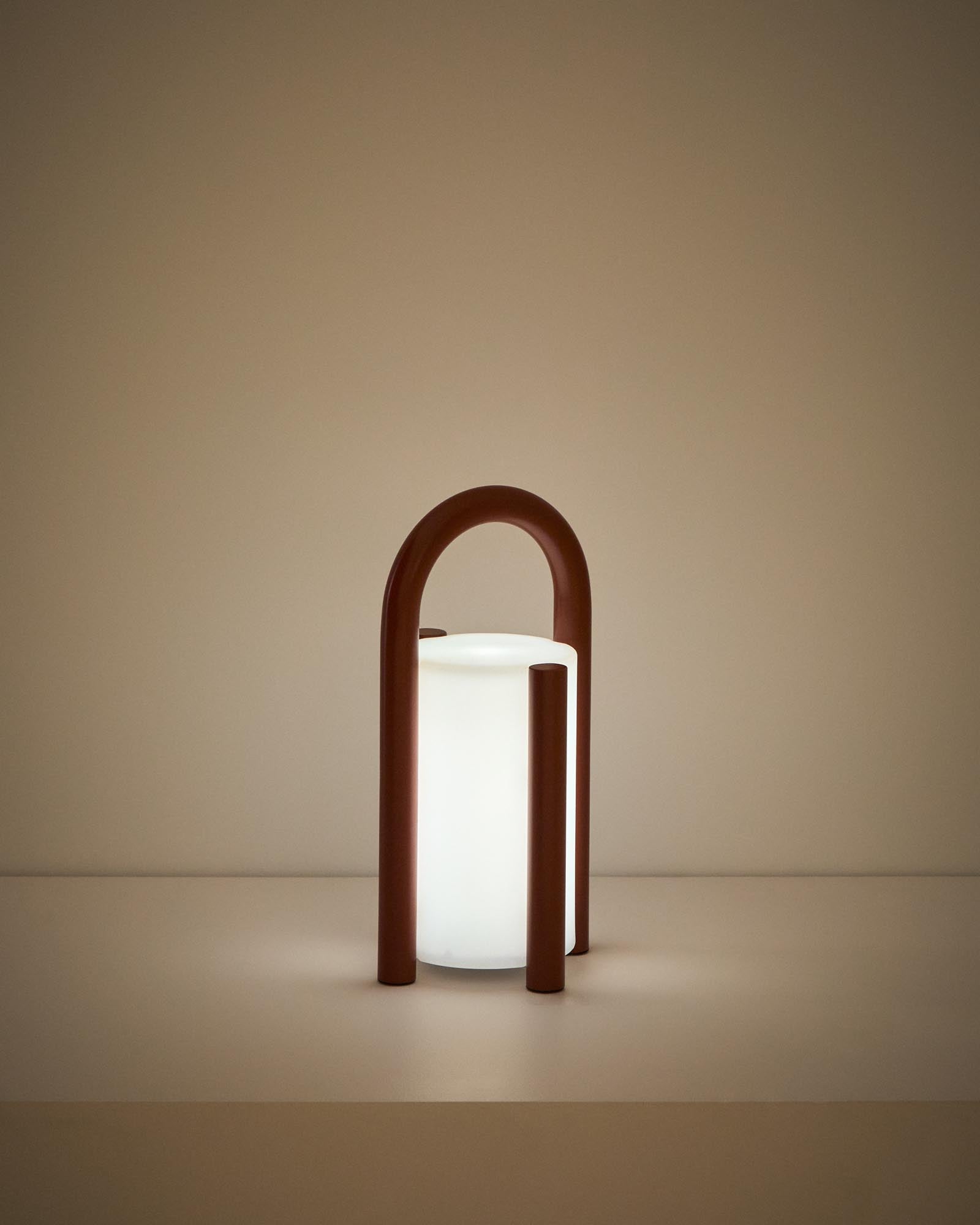Kleine, stilvolle Tischlampe Leros aus strapazierfähigem Polyethylen und terrakottafarbenem Stahl, ideal für gemütliche Outdoor-Atmosphäre.