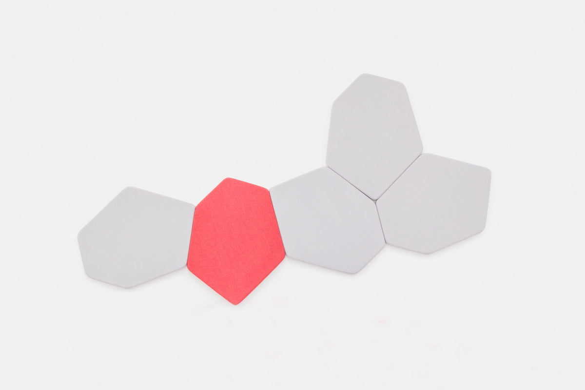 Sechseckiges Wandpaneel Bazalto von Mdd in Blau, einseitig gepolstert mit Stoffbezug und Spanplattenrahmen, montiert an einer Wand.