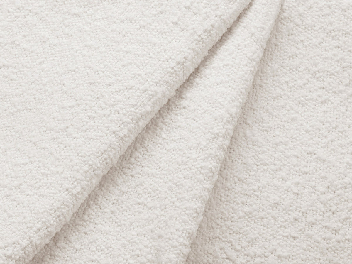 Weisses 4er Sofa Kate von Micadoni mit strukturiertem Bouclé-Stoff, schwarzen Kunststoffbeinen und breiter Sitzfläche.