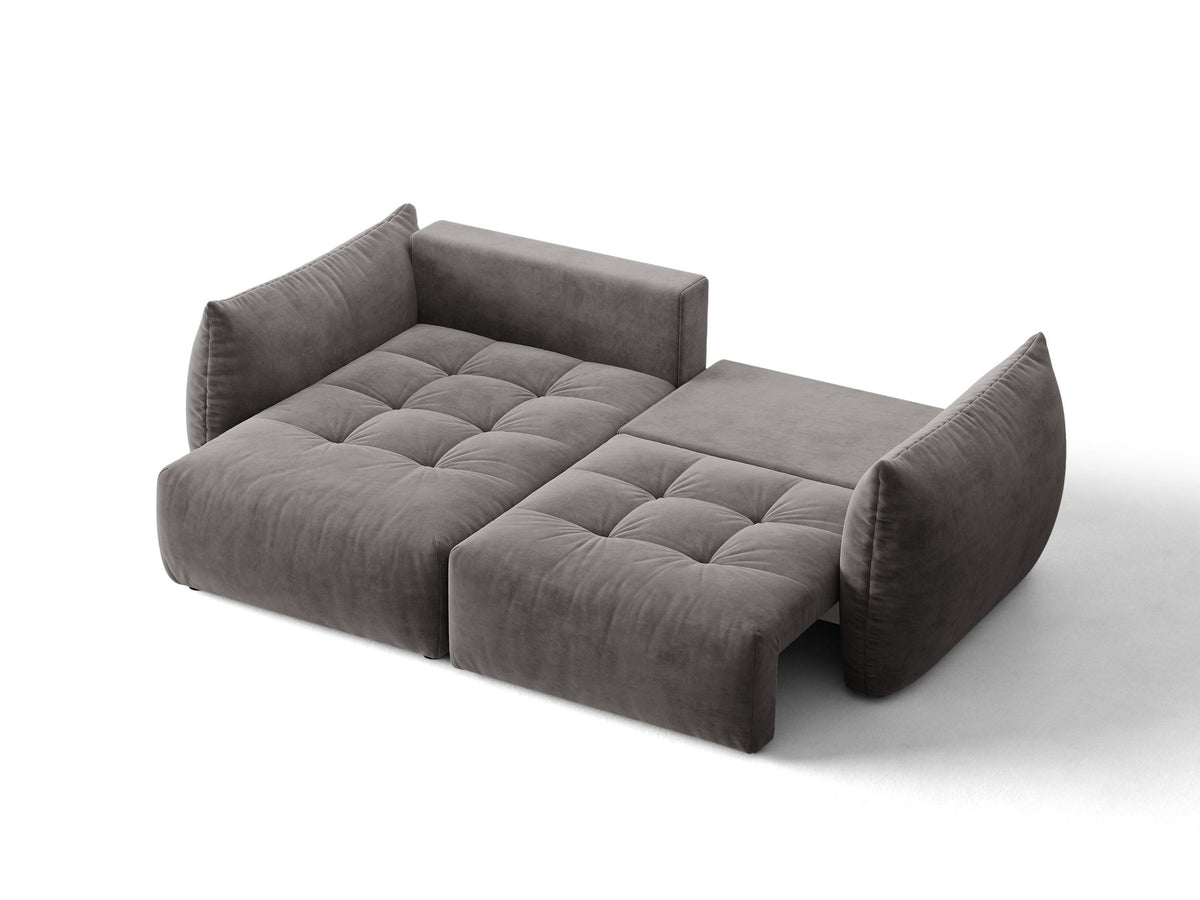 Ecksofa Bloom in Sand mit Velours-Bezug, schwarzen Kunststoffbeinen und ausklappbarer Schlaffunktion samt Bettkasten unter der Sitzfläche.