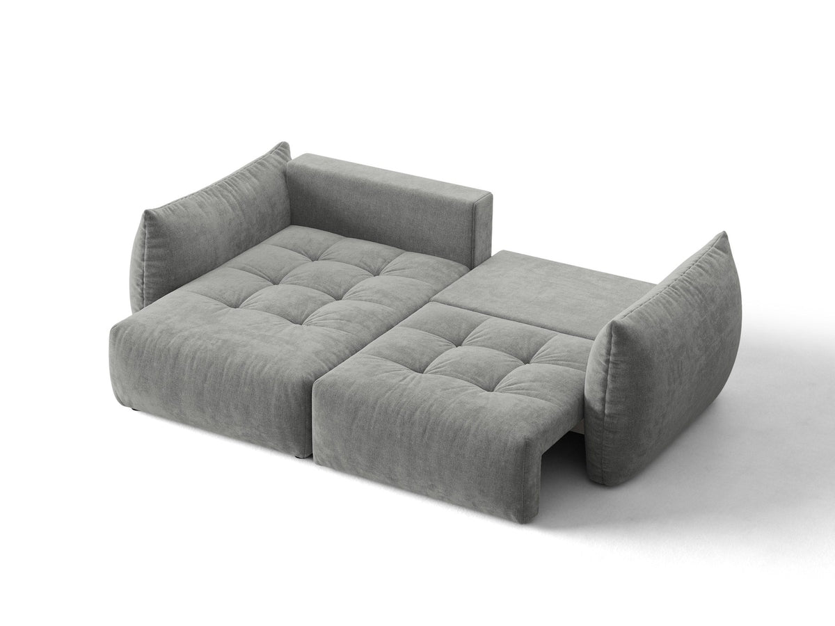 Ecksofa Bloom in Sand mit Velours-Bezug, schwarzen Kunststoffbeinen und ausklappbarer Schlaffunktion samt Bettkasten unter der Sitzfläche.