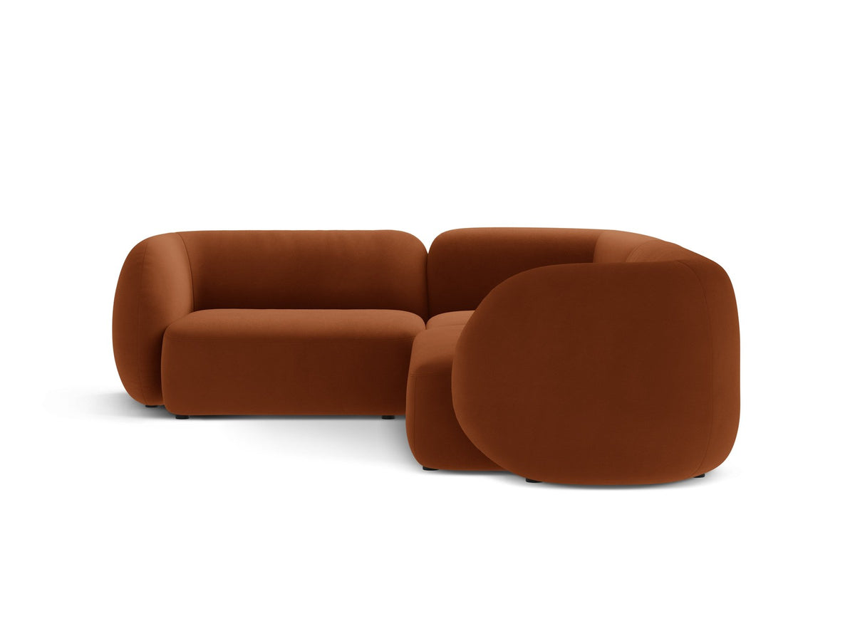 Weisses Ecksofa links Kate von Micadoni mit Bouclé-Stoff Baloo, schwarzen Kunststoffbeinen und niedriger Rückenlehne im Wohnraum.