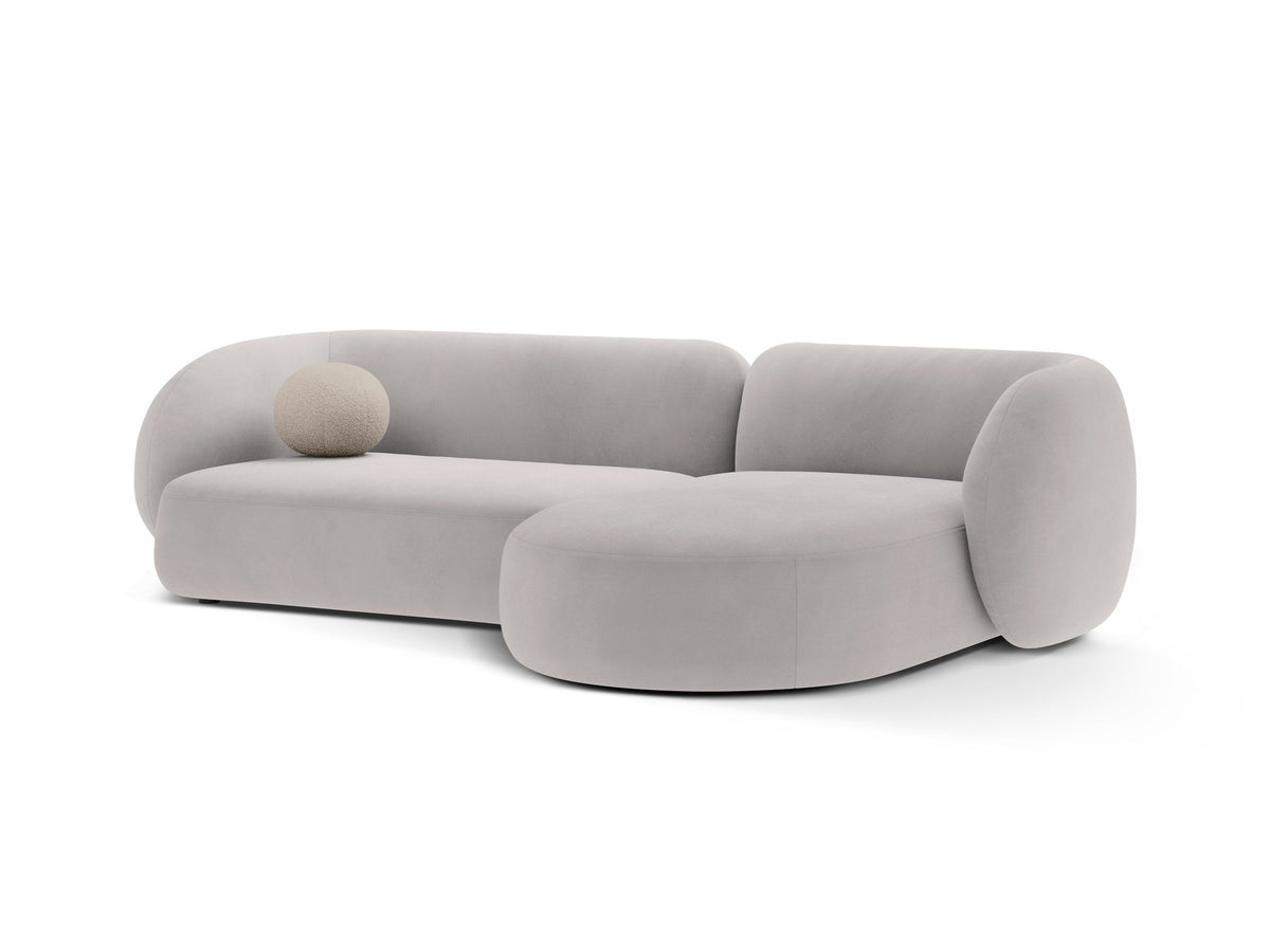 Weisses Ecksofa rechts Kate von Micadoni mit strukturiertem Bouclé-Stoff, schwarzen Kunststoffbeinen und niedriger Rückenlehne.