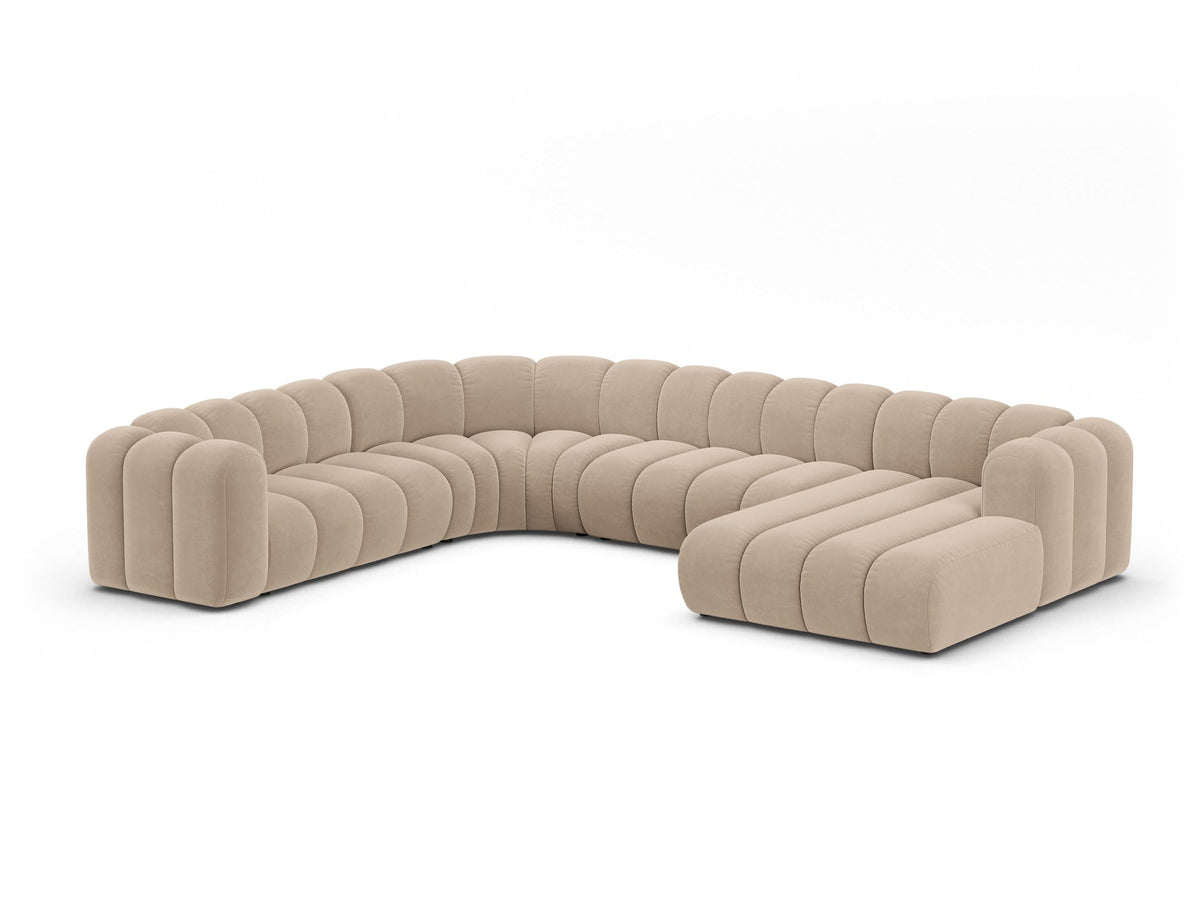 Foto eines modularen Ecksofas links in leichtem Beige aus Samtstoff Venus, mit schwarzen Kunststoffbeinen und breiter Sitzfläche.