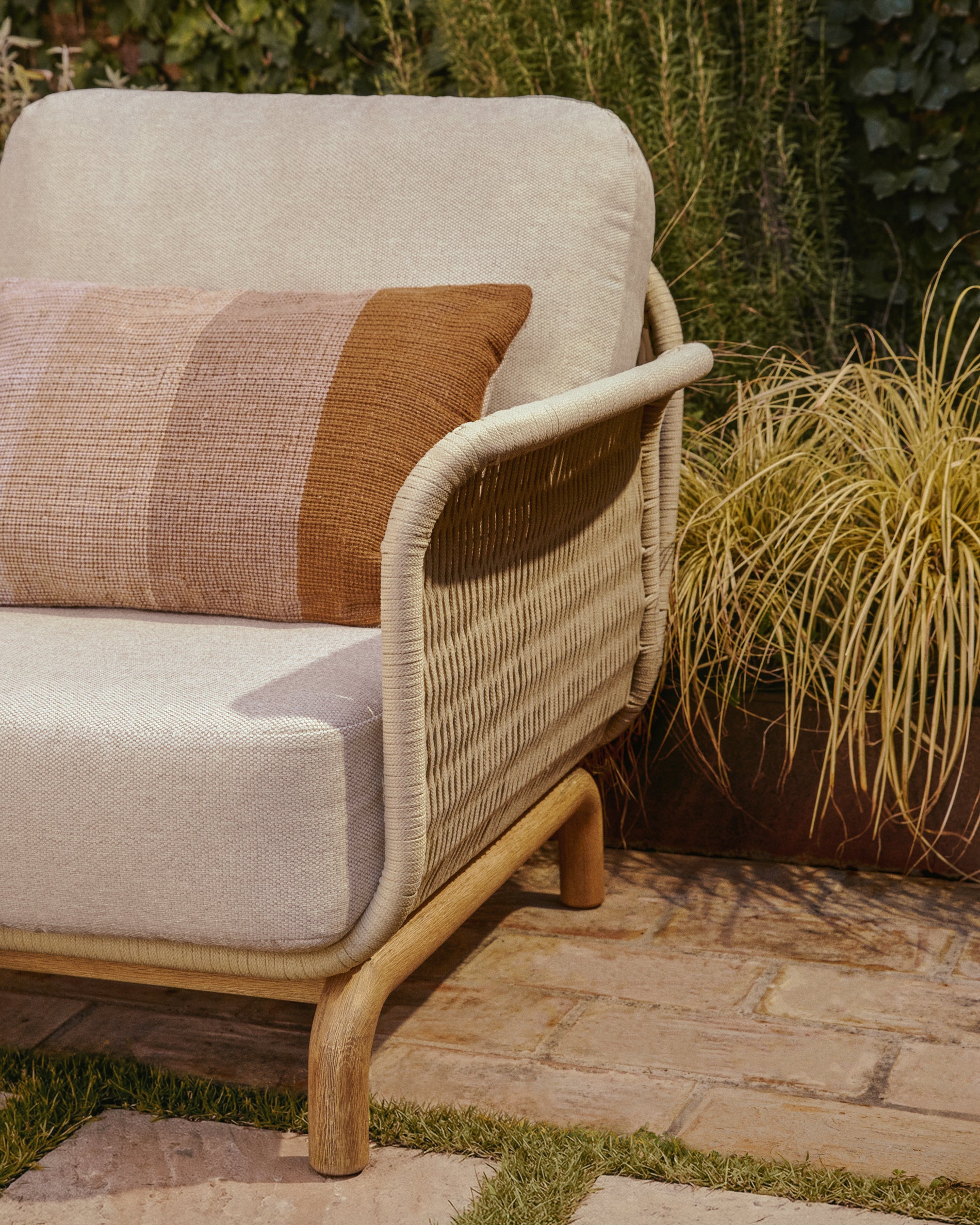 Gemütlicher Sessel Alipa aus solidem Akazienholz, umwickelt mit ecrufarbenem Seil, perfekt für stilvolle Outdoor-Bereiche.