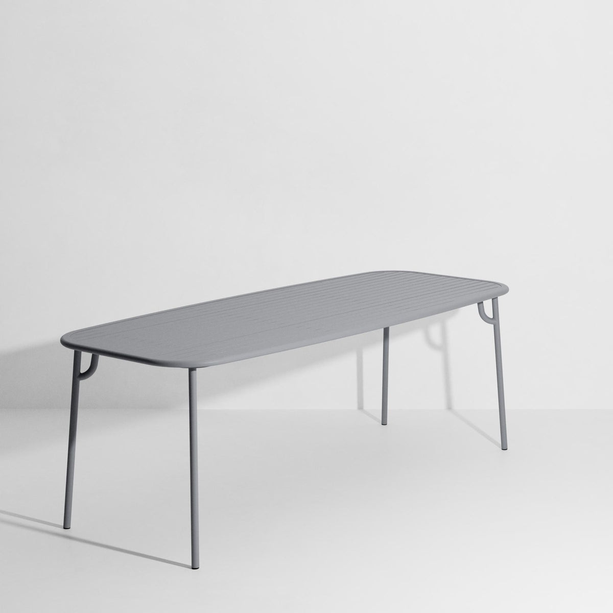 Week-End Tisch Large von Petite Friture in Pigeon Blue: ovaler Gartentisch aus Aluminium mit gerahmten, streifenartigen Lamellen.