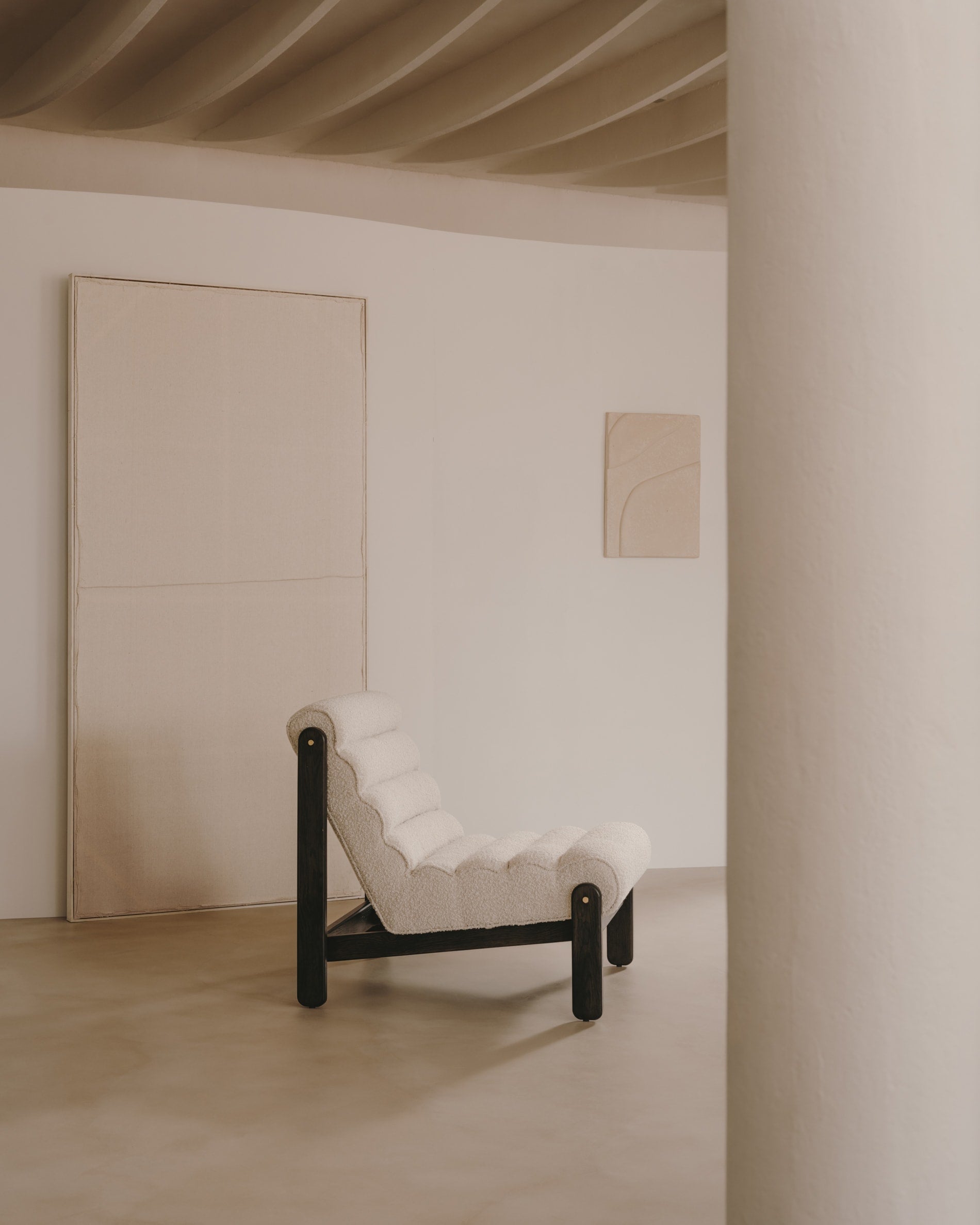 Magira armchair in <tc>wEIS</tc> bouclé and solid oak with dark finish