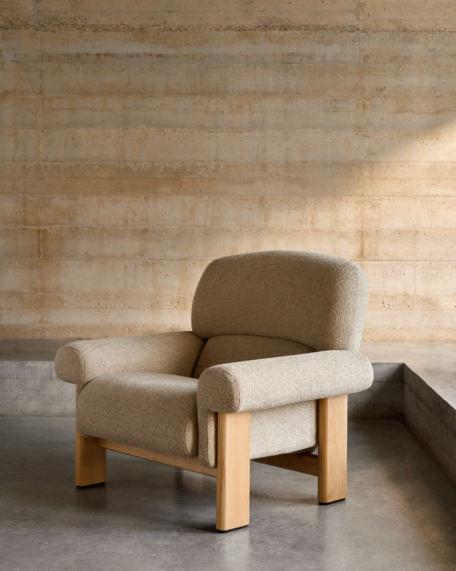 Armchair nema made of beige chenille and legs made of solid ash wood with natural
