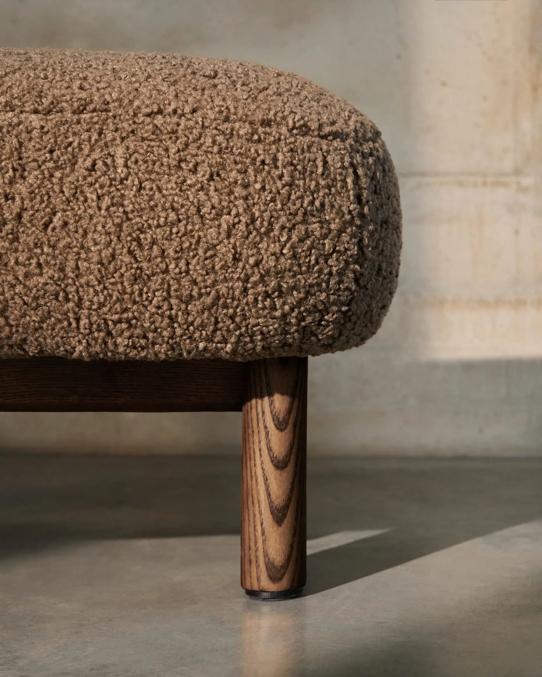 Elegante Fußstütze mit taupefarbenem Bouclé-Bezug, Beinen aus Eschenholz mit Walnuss-Finish, FSC-zertifiziert, Maße 65x55,4 cm.