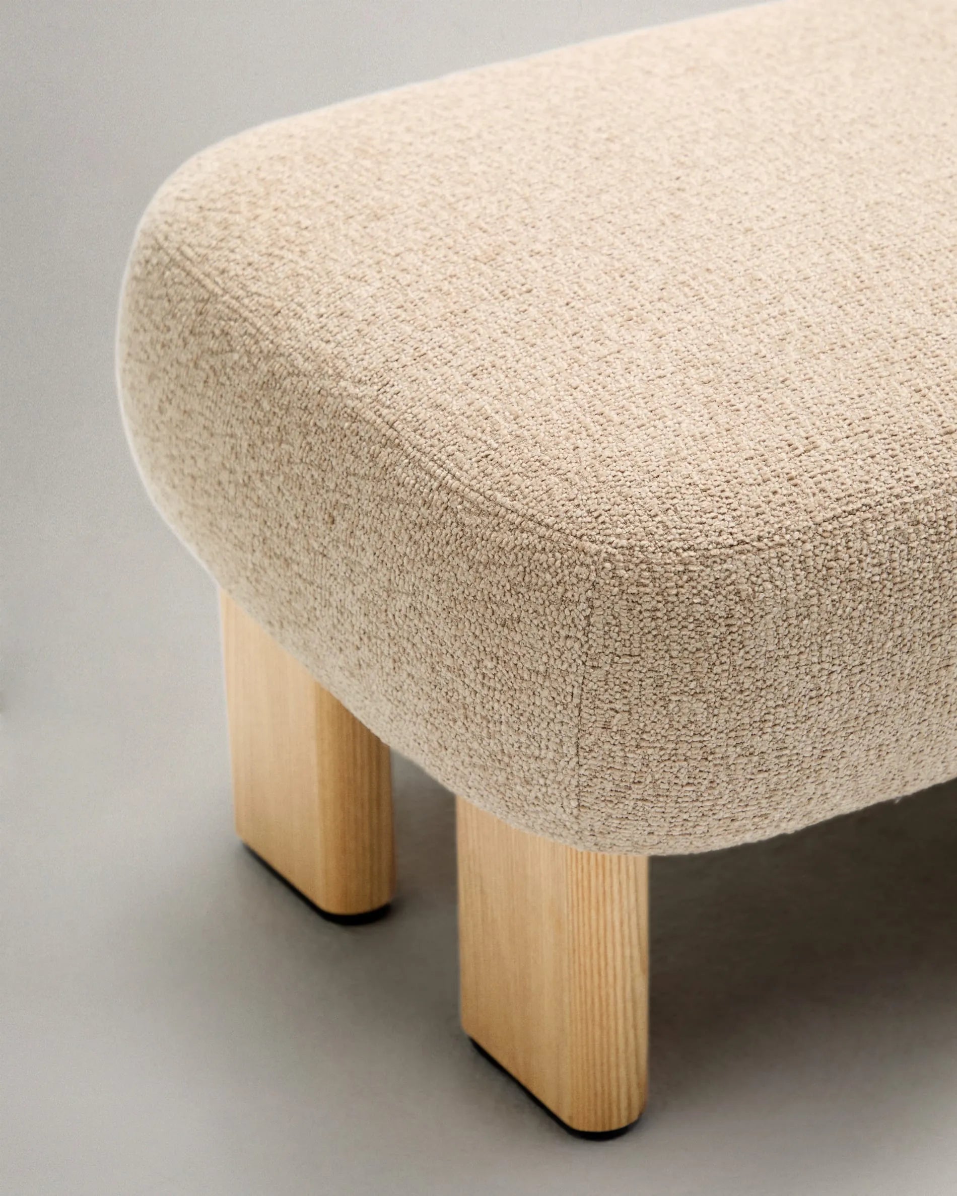 Stilvolle Fußstütze mit beigem Chenille-Bezug, Eschenholzbeinen im Naturfinish, FSC-zertifiziert, Maße 65x55,4cm, von Kave Home.