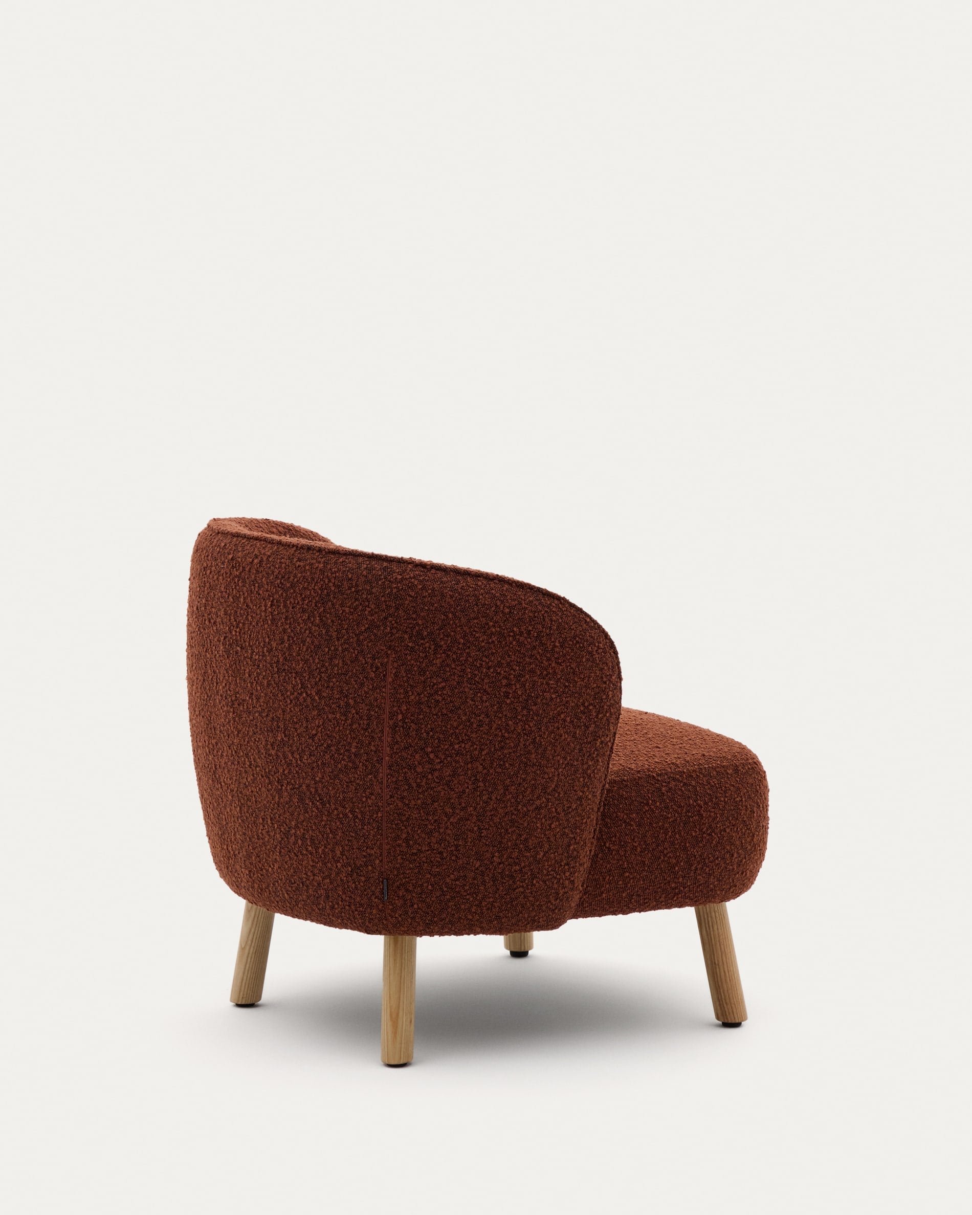 Ulit armchair made of terracotta<tc>ott</tc>a-colored sheepskin and legs made of solid beech wood with natural