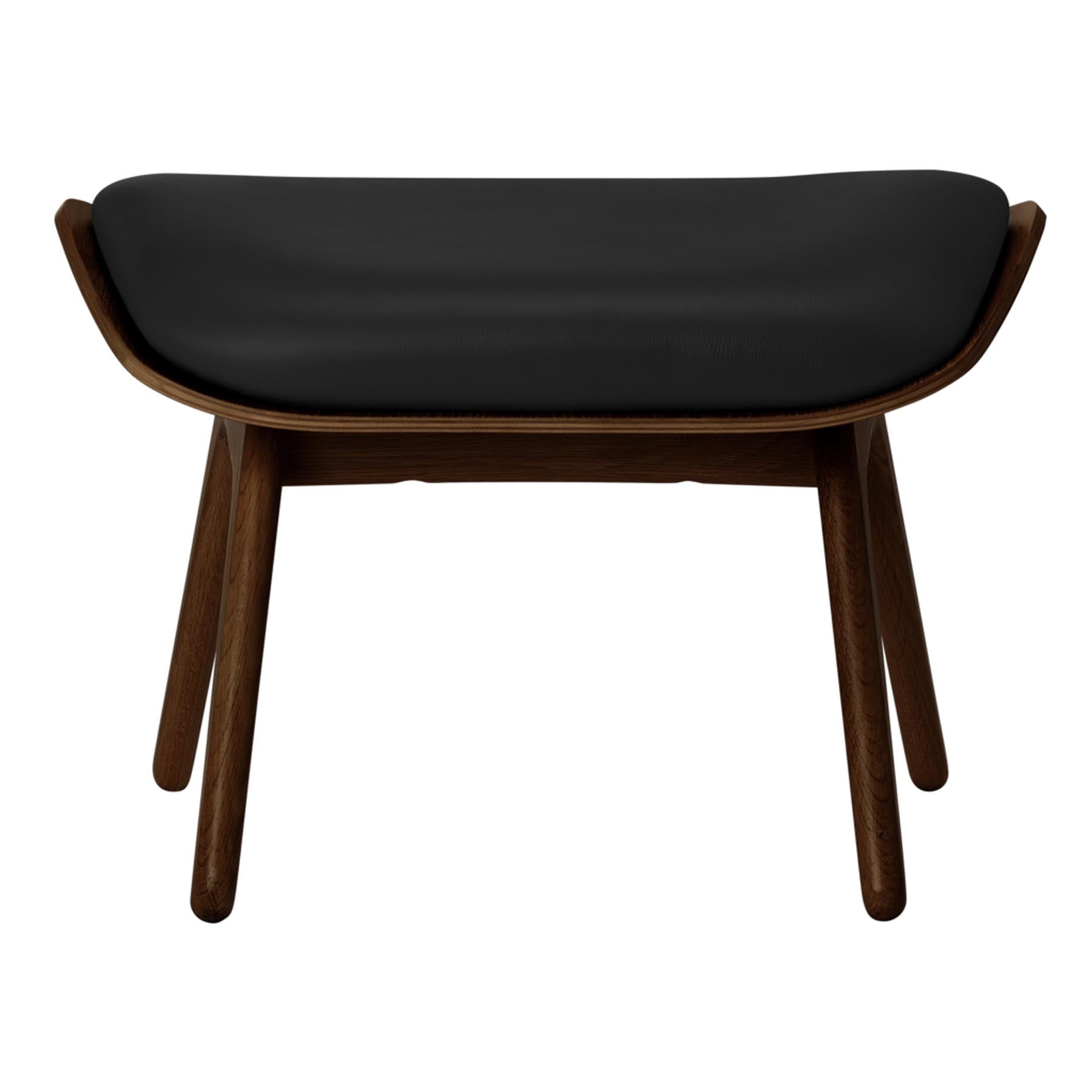Eleganter schwarzer Ottoman von Umage, ideal für gemütliche Leseecken und modernes Wohndesign, bietet hohen Sitzkomfort und stilvolle Akzente.