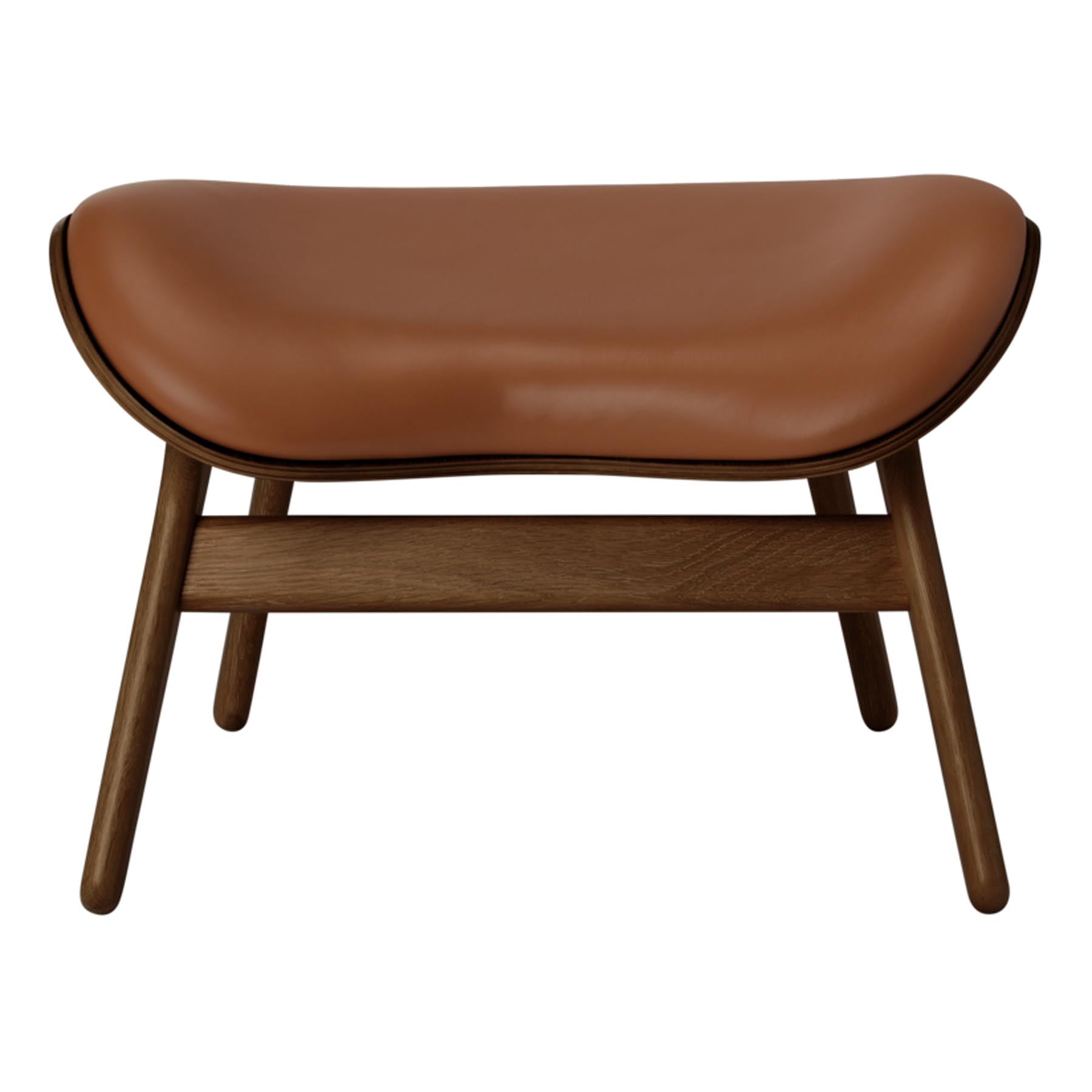 Stilvoller Ottoman in warmem Cognac, perfekt für moderne Wohnräume und als Blickfang für entspannte Gespräche.