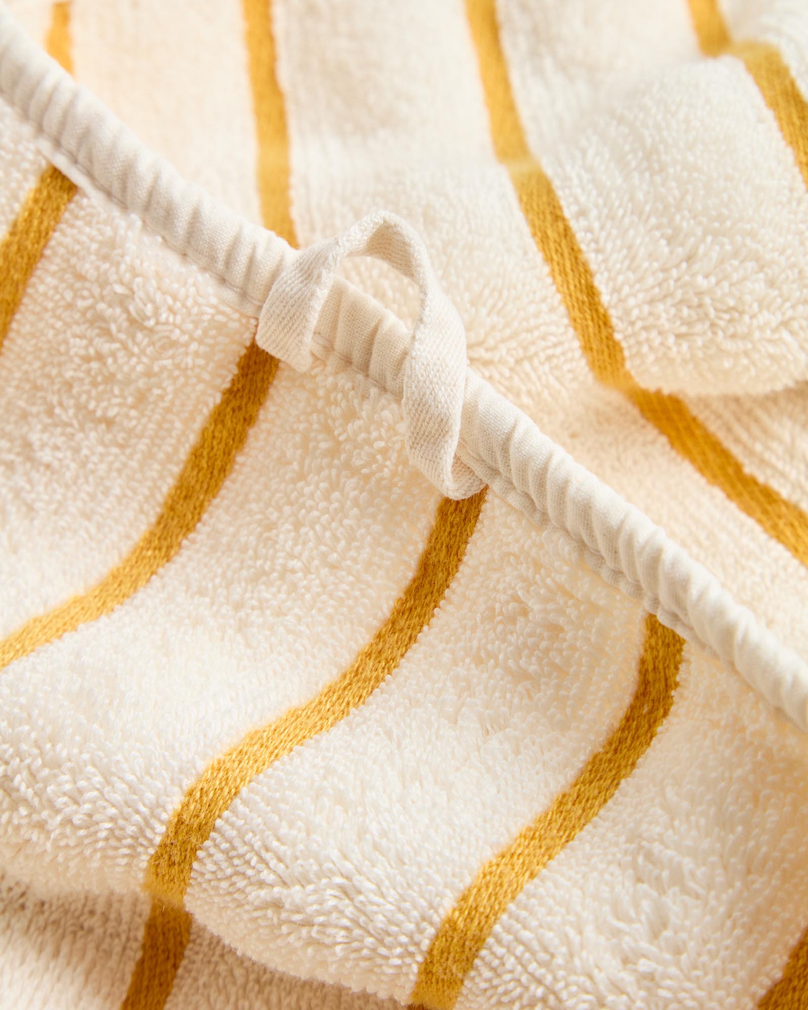 Stylisches Handtuch Dorane in leuchtendem Gelb mit eleganten Streifen, gefertigt aus 100 % Baumwolle, ideal für Bad und Wellness, Größe 50 x 90 cm.
