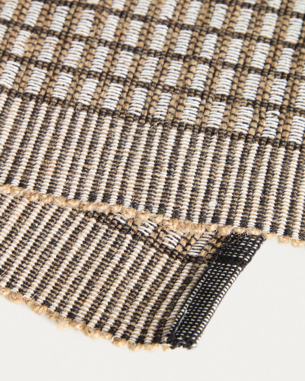 Zwei senfgelbe Tischsets aus Baumwolle und Jute mit strukturierter Webung, rechteckige Form, auf einer Tischplatte platziert.