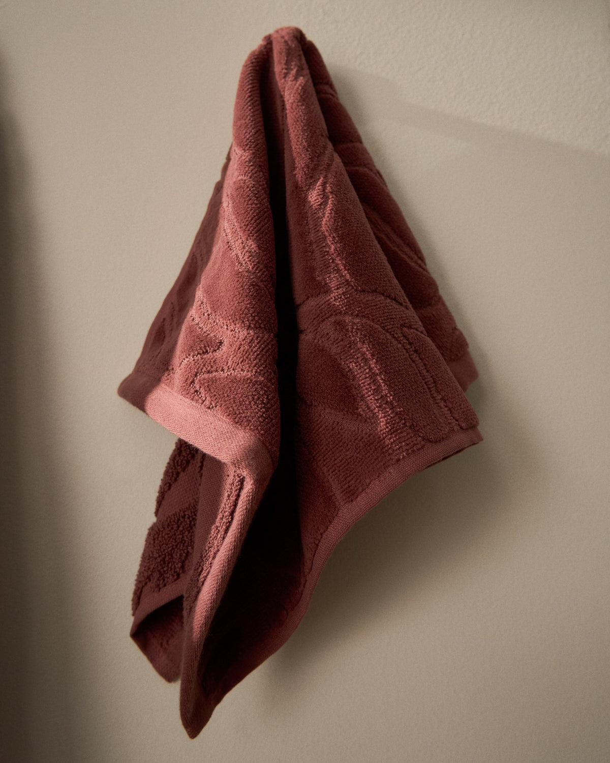 Weinrotes Toilettenhandtuch aus 100% Baumwolle mit Jacquard-Muster und samtiger Oberfläche, Format 30 x 50 cm.